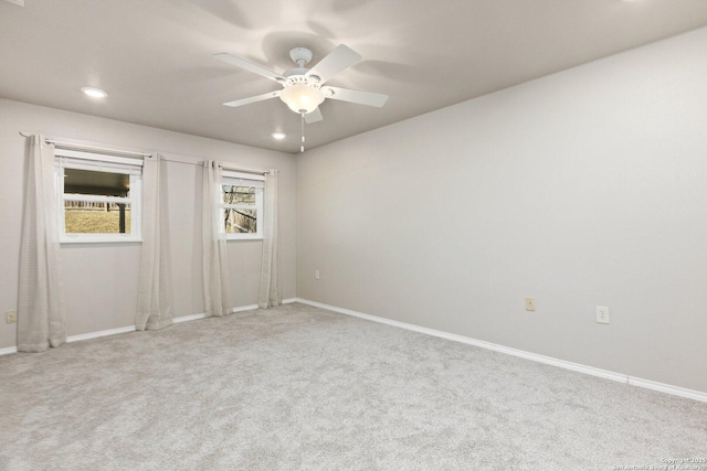 carpeted spare room with ceiling fan