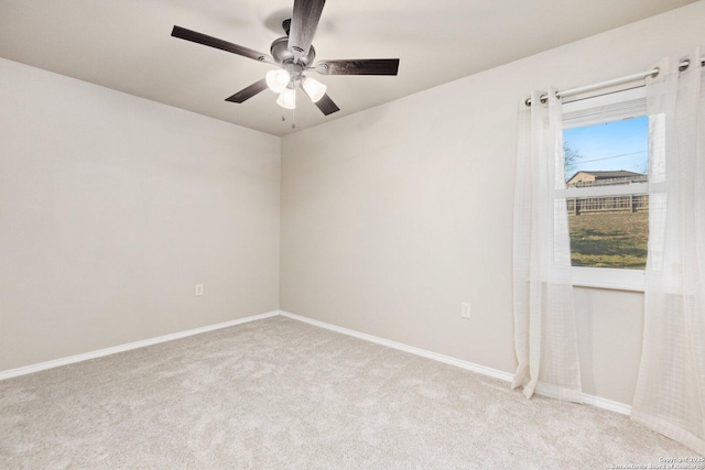 spare room featuring light carpet and ceiling fan