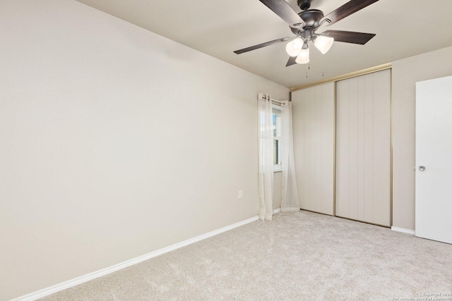 unfurnished bedroom featuring a closet, light carpet, and ceiling fan