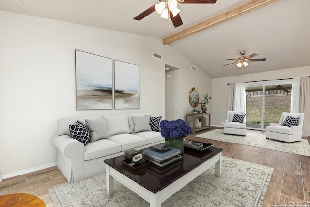 living room with lofted ceiling with beams