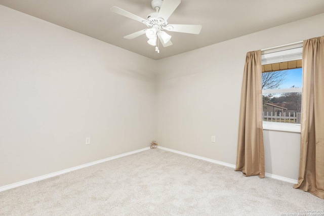 spare room featuring light colored carpet and ceiling fan