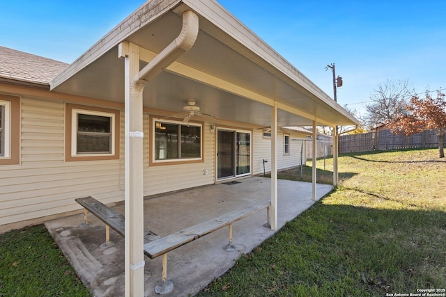 rear view of house featuring a patio and a lawn