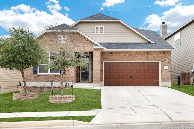 view of front of property featuring a front yard and a garage