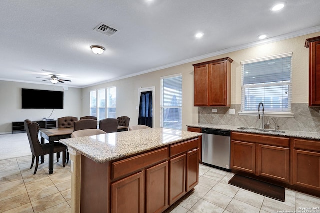 kitchen with stainless steel dishwasher, ornamental molding, ceiling fan, sink, and a kitchen island