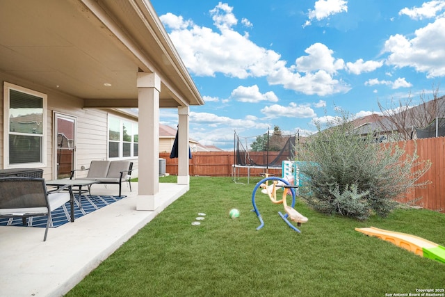 view of yard featuring a patio and a trampoline