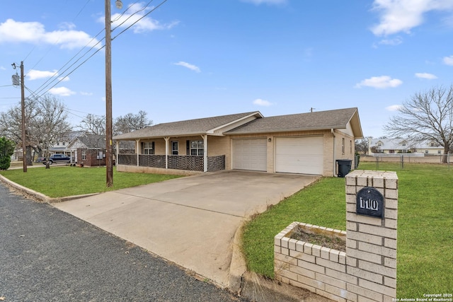 single story home featuring a porch, a front yard, and a garage