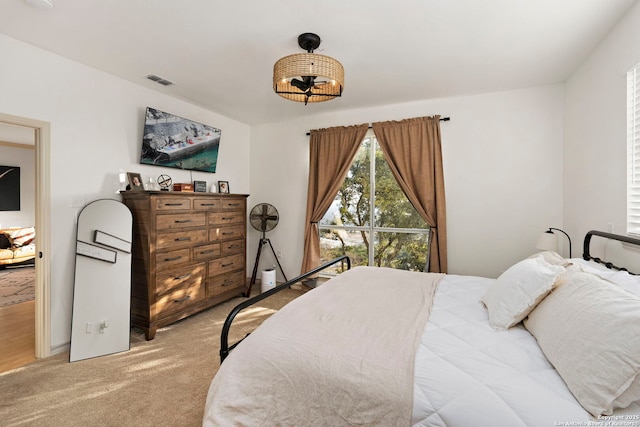 bedroom featuring light colored carpet