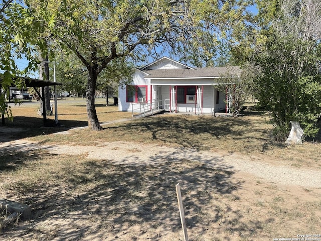 view of front of house with cooling unit and a porch