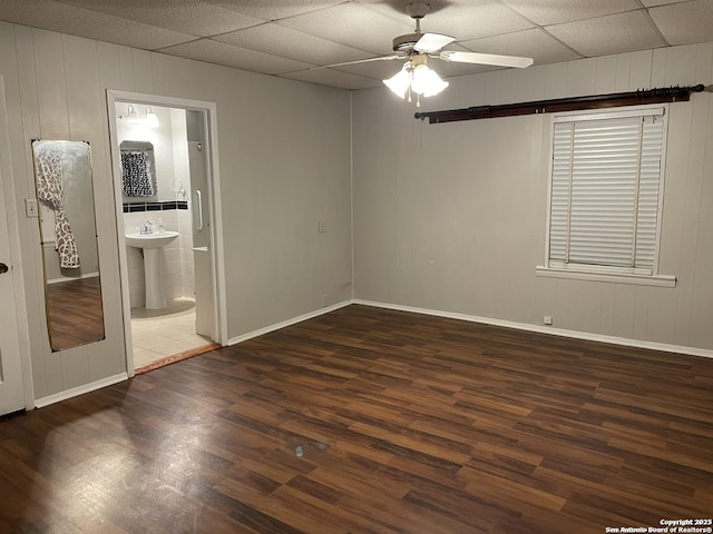 unfurnished room featuring ceiling fan, sink, and dark hardwood / wood-style floors