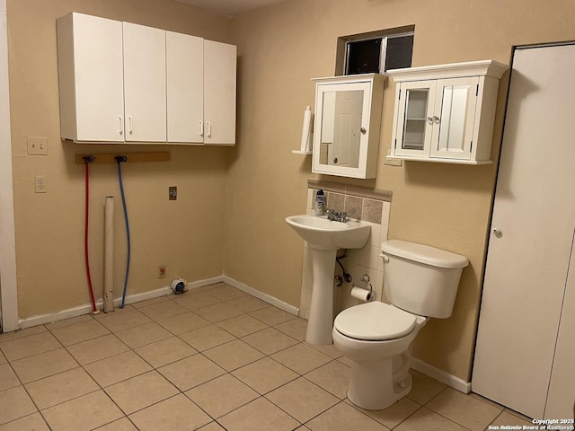 bathroom with tile patterned floors, sink, and toilet