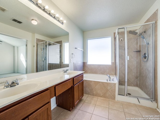 bathroom with tile patterned floors, vanity, and shower with separate bathtub