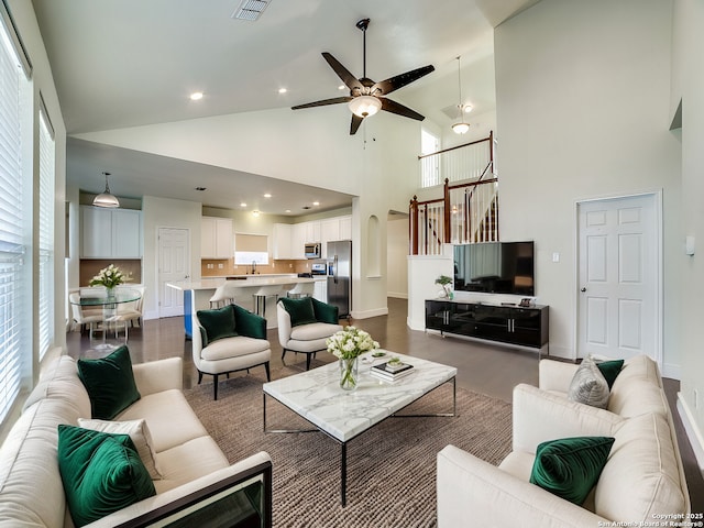 living room with plenty of natural light and high vaulted ceiling