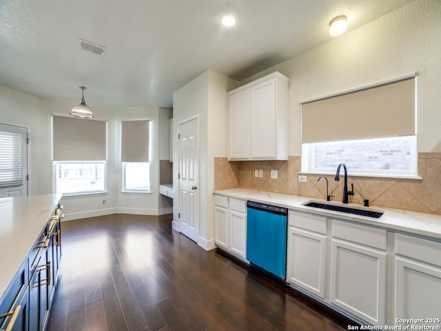 kitchen featuring white cabinets, dishwasher, sink, and hanging light fixtures