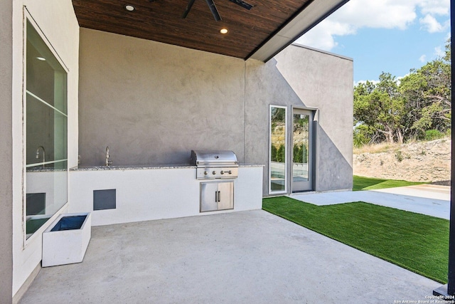 view of patio / terrace featuring a grill, area for grilling, and ceiling fan