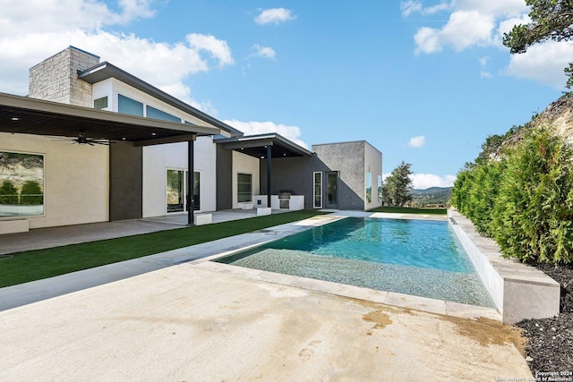 view of swimming pool with a patio area and ceiling fan