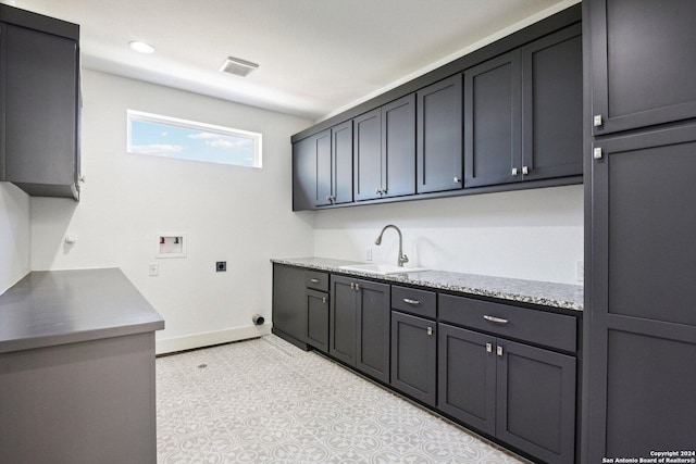 clothes washing area with cabinets, sink, washer hookup, and hookup for an electric dryer