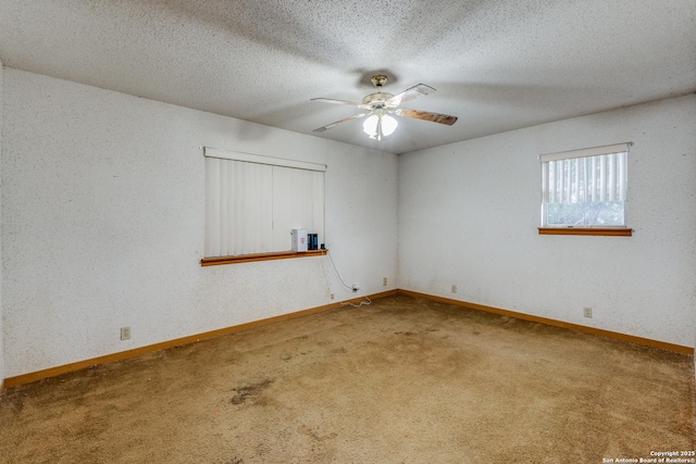 spare room with carpet flooring, ceiling fan, and a textured ceiling