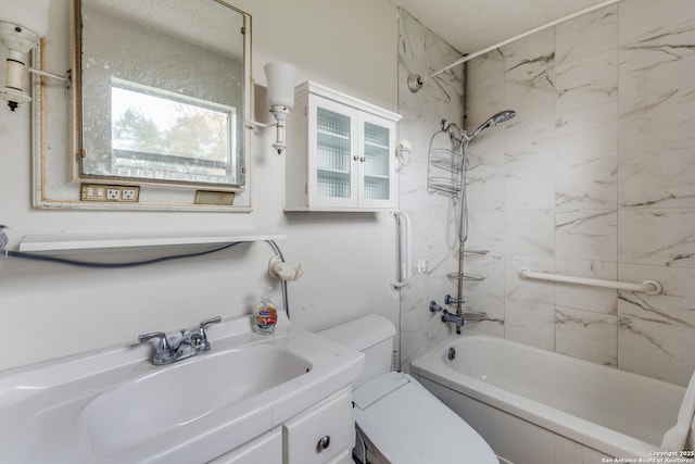 full bathroom featuring vanity, tiled shower / bath combo, and toilet