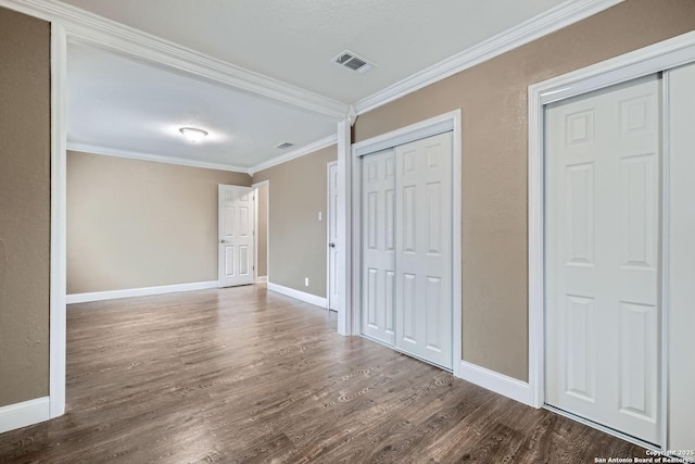 unfurnished bedroom featuring dark hardwood / wood-style flooring and ornamental molding