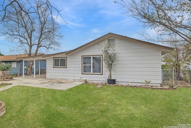 back of house with a lawn and a patio area