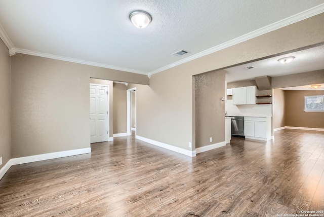 unfurnished living room featuring a textured ceiling, wood-type flooring, and ornamental molding