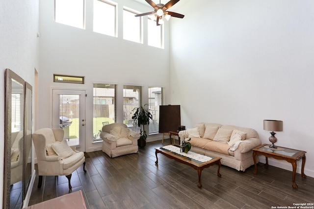 living room featuring ceiling fan and a towering ceiling