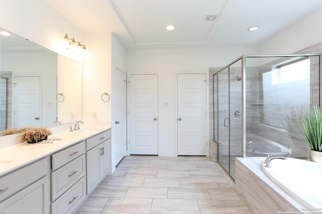 bathroom with vanity and independent shower and bath