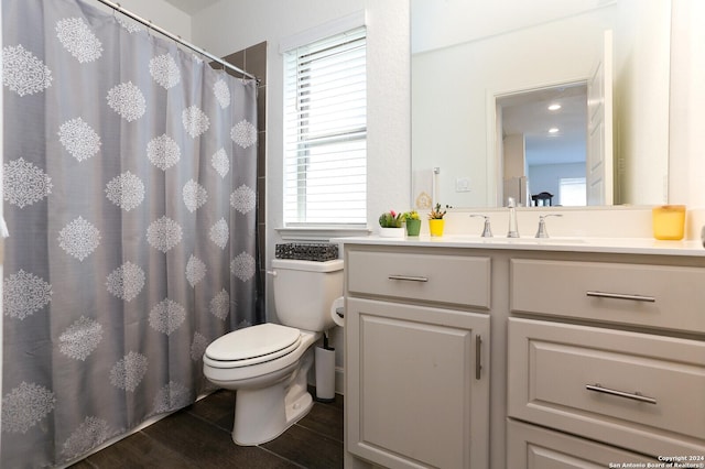 bathroom with hardwood / wood-style flooring, vanity, toilet, and a shower with shower curtain