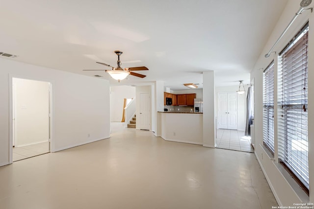 unfurnished living room featuring ceiling fan