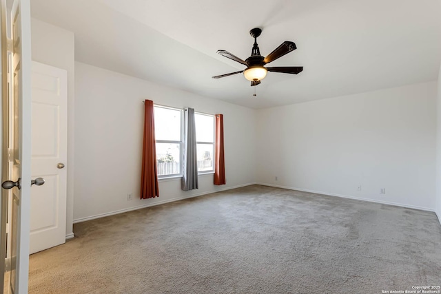 empty room featuring light colored carpet and ceiling fan