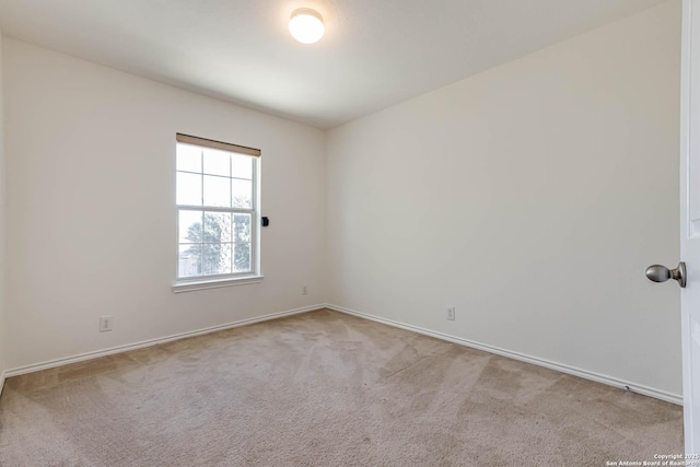 unfurnished room with light carpet