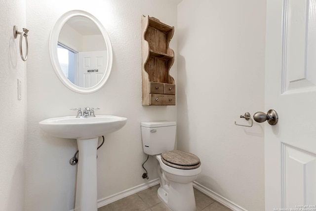 bathroom with tile patterned floors and toilet