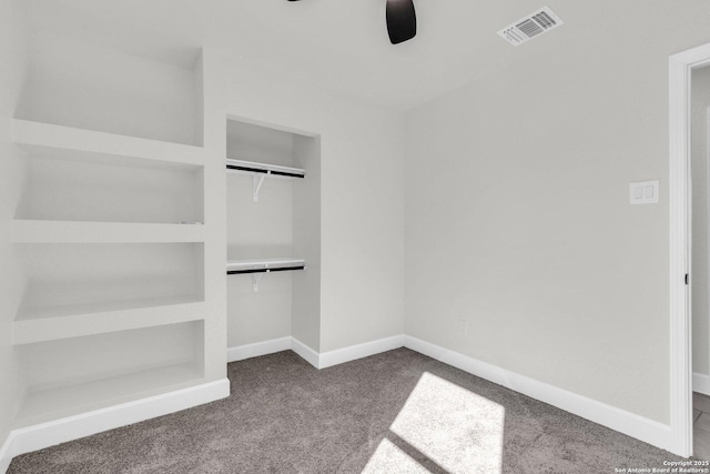 unfurnished bedroom with carpet flooring, ceiling fan, and a closet