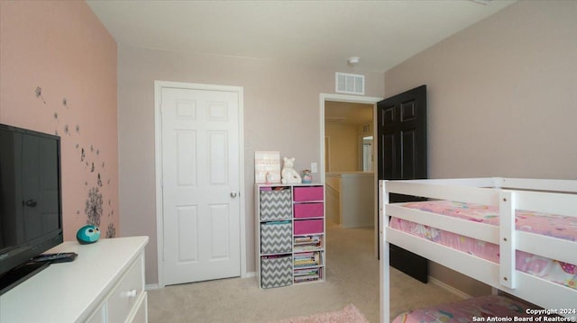 bedroom with light colored carpet