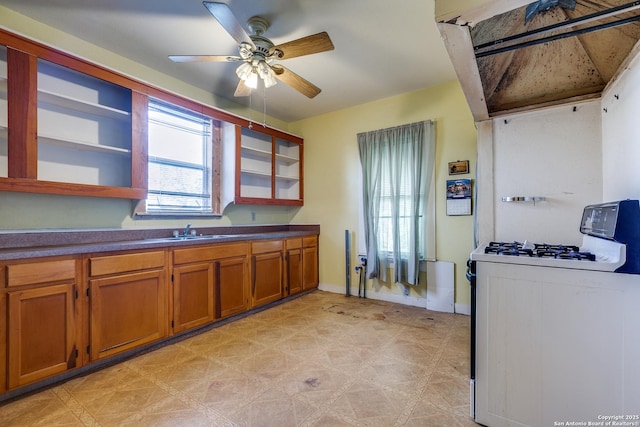 kitchen with ceiling fan, sink, and white gas range oven