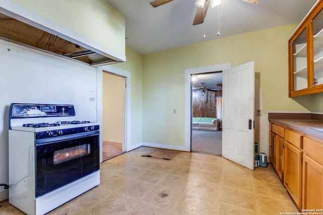 kitchen featuring white gas range oven and ceiling fan