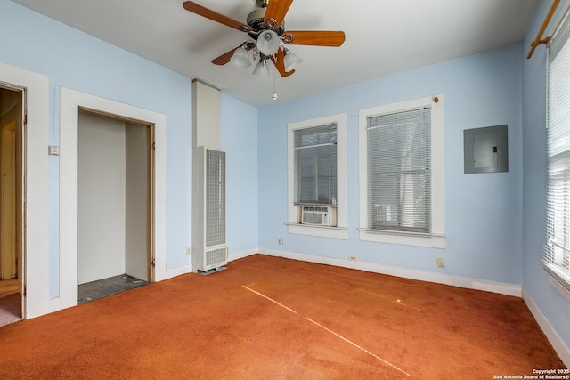 carpeted empty room with ceiling fan, cooling unit, and electric panel