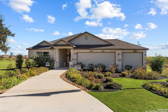 view of front of home with a front yard and a garage