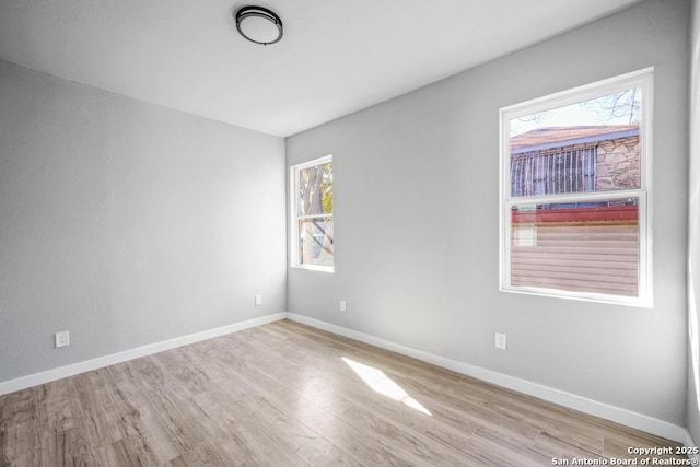 unfurnished room featuring light hardwood / wood-style floors and a healthy amount of sunlight