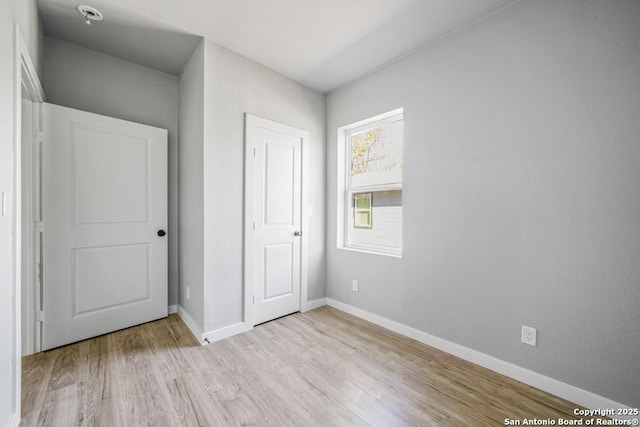 unfurnished bedroom with light hardwood / wood-style floors