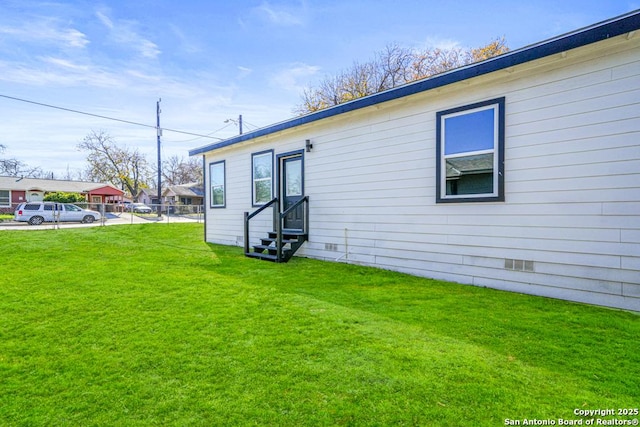 rear view of property featuring a lawn