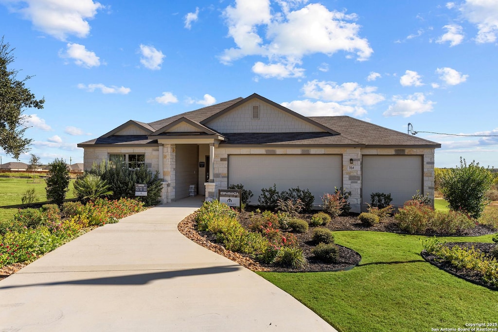 view of front of house with a front yard and a garage