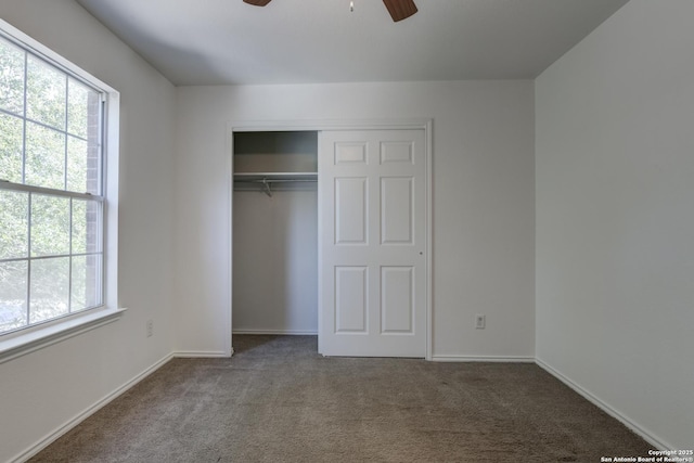 unfurnished bedroom with a closet, carpet floors, and ceiling fan