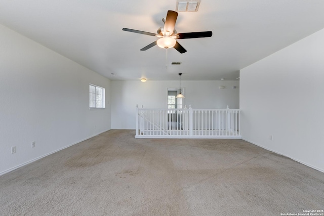 unfurnished room with ceiling fan and light colored carpet