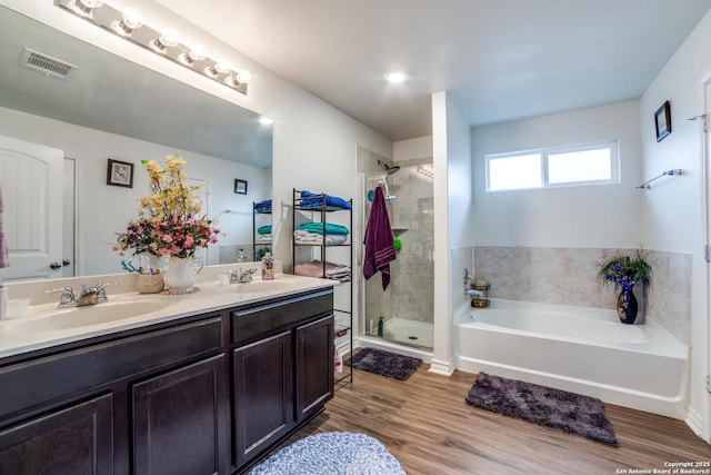 bathroom featuring vanity, hardwood / wood-style flooring, and separate shower and tub