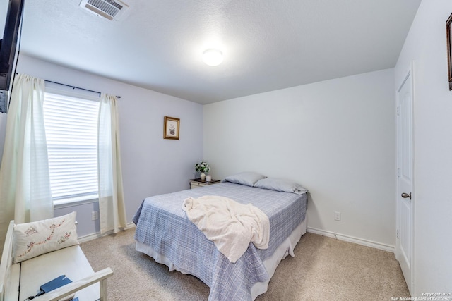 bedroom with light colored carpet