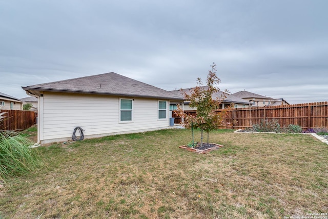 rear view of house with a yard