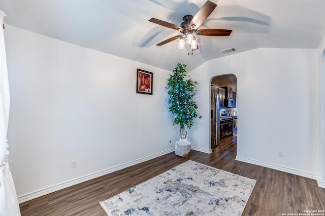 unfurnished room with dark wood-type flooring, ceiling fan, and lofted ceiling