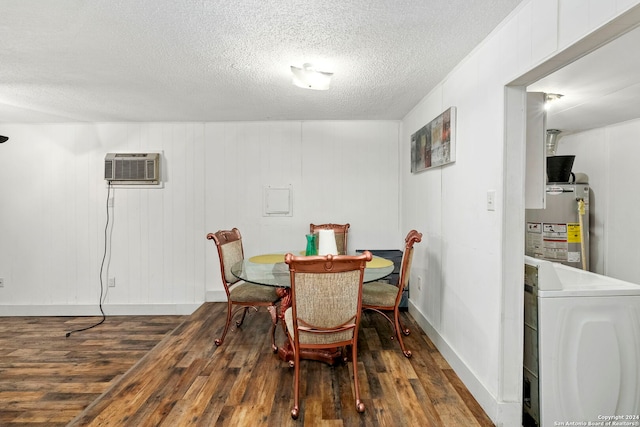 dining space with an AC wall unit, washer / clothes dryer, dark wood-type flooring, and gas water heater