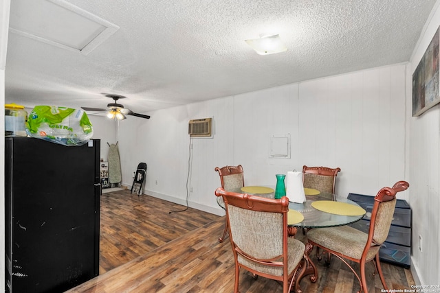 dining area featuring a textured ceiling, ceiling fan, dark hardwood / wood-style flooring, and a wall mounted air conditioner